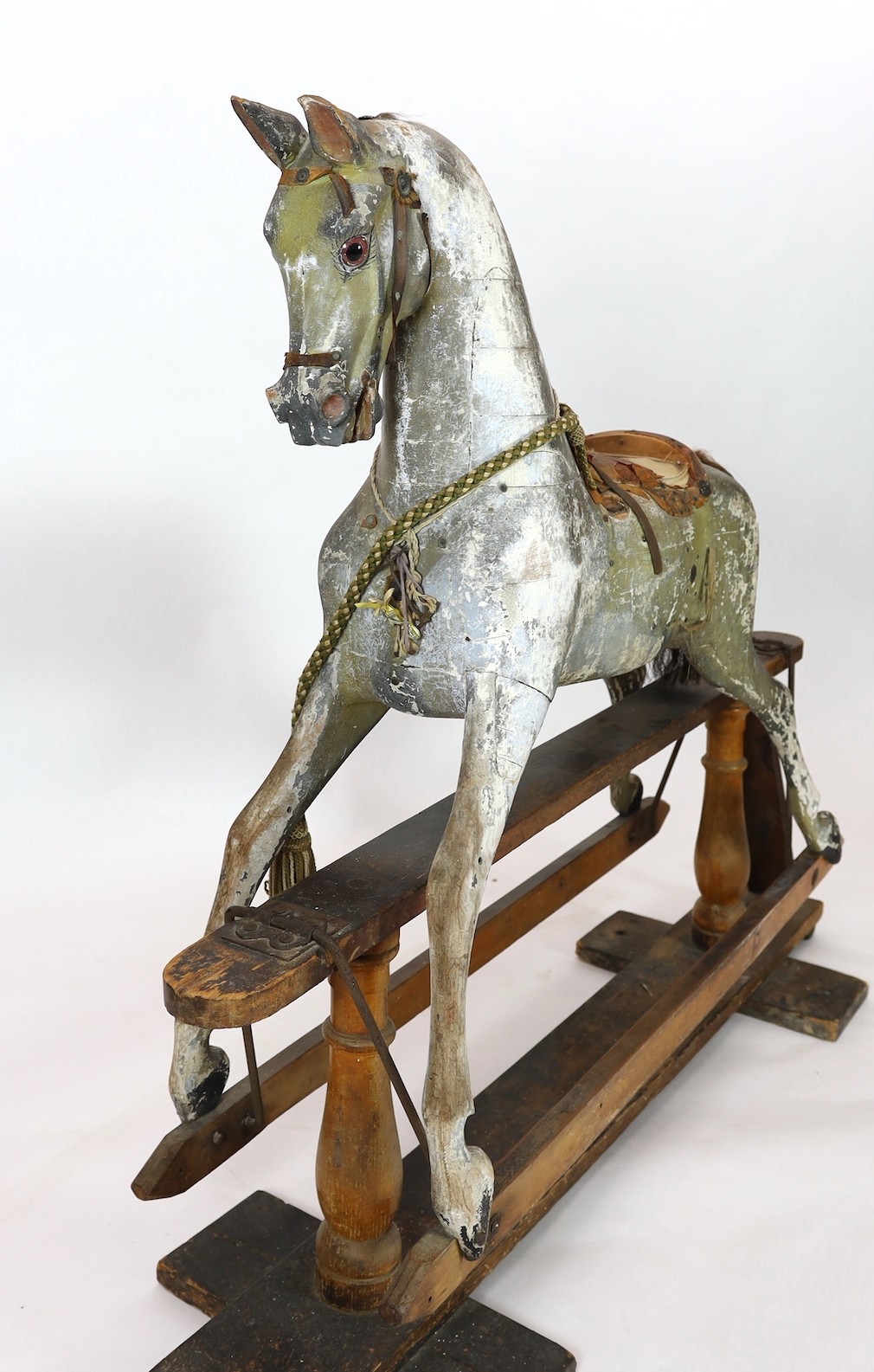 A Victorian carved and painted wood rocking horse, 174cm long 145cm high